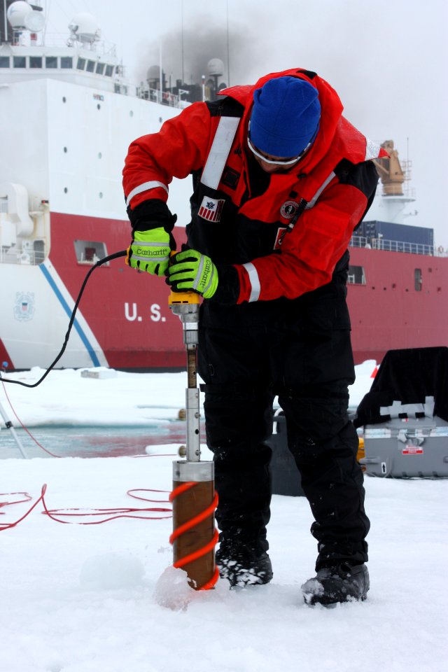 Benny Hopson from the Barrow Arctic Science Consortium in Alaska drills a core sample from sea ice in the Chukchi Sea on July 4, 2010.