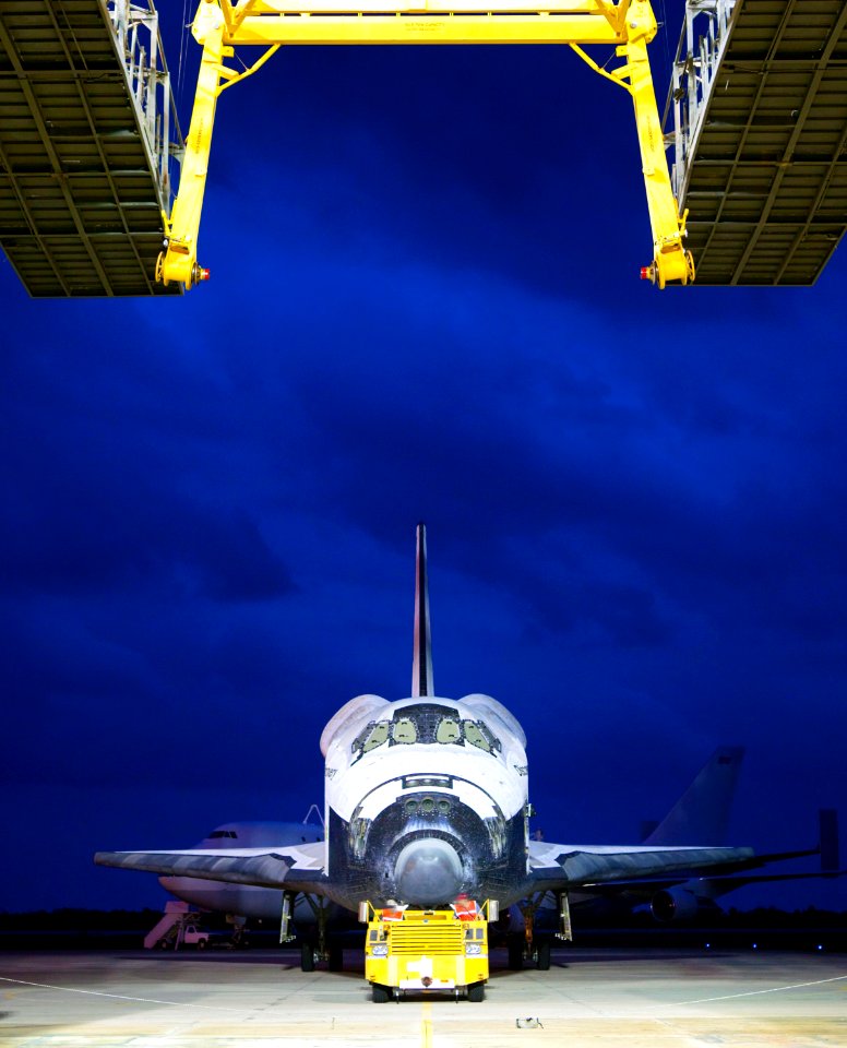 Space shuttle Discovery is towed into position at the mate-demate device, at the Shuttle Landing Facility, at NASA’s Kennedy Space Center in Florida.
