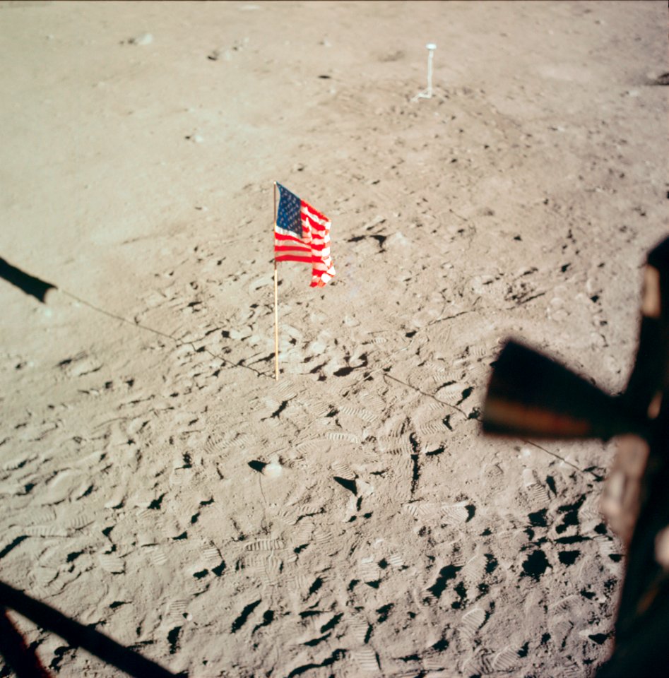 The flag of the United States and the footprints of astronauts Neil A. Armstrong and Edwin E. Aldrin Jr., deployed on the surface of the moon.