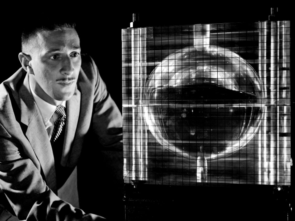 NASA Researcher Andy Stofan views a small-scale tank built to study the sloshing characteristics of liquid hydrogen at NASA.