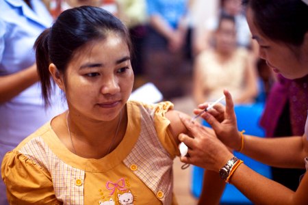 A woman receiving an influenza vaccination at the Maternal and Child Hospital in Vientiane, Laos. Original image sourced from US Government department: Public Health Image Library, Centers for Disease Control and Prevention. Under US law this image is copyright free, please credit the government department whenever you can”.