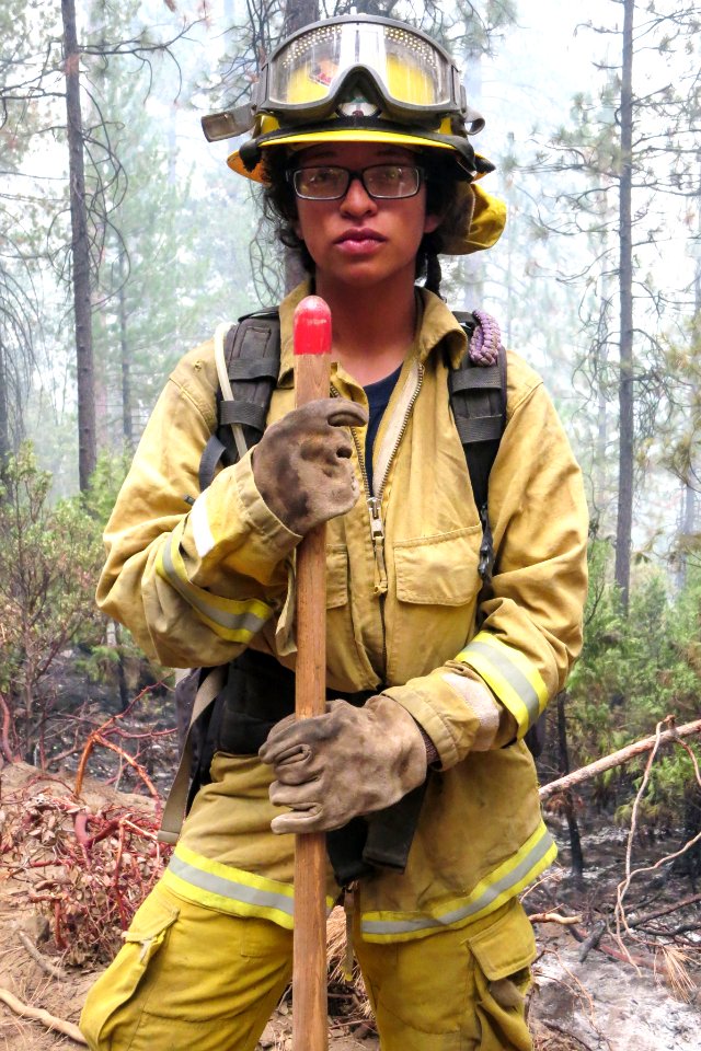 Firewoman extinguishing trees in forest. Original image sourced from US Government department: Public Health Image Library, Centers for Disease Control and Prevention. Under US law this image is copyright free, please credit the government department whenever you can”.