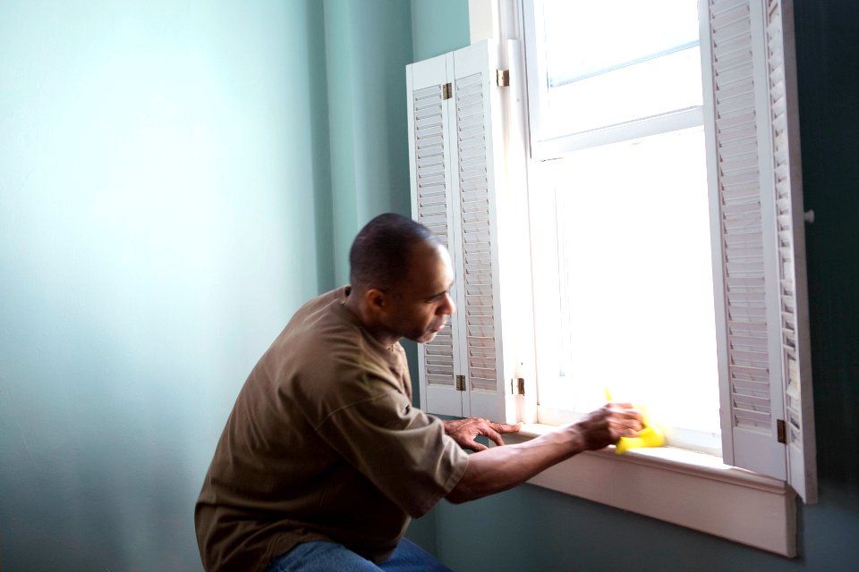 A man cleaning window. Original image sourced from US Government department: Public Health Image Library, Centers for Disease Control and Prevention. Under US law this image is copyright free, please credit the government department whenever you can”.