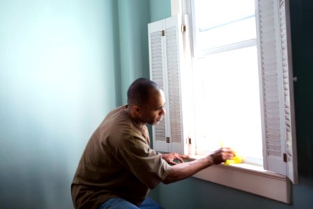 A man cleaning window. Original image sourced from US Government department: Public Health Image Library, Centers for Disease Control and Prevention. Under US law this image is copyright free, please credit the government department whenever you can”.