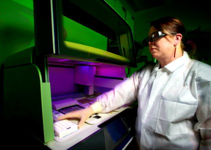 A scientist using a whole genome DNA sequencer, in order to determine the “DNA fingerprint” of a specific bacterium. Original image sourced from US Government department: Public Health Image Library, Centers for Disease Control and Prevention. Under US law this image is copyright free, please credit the government department whenever you can”. photo