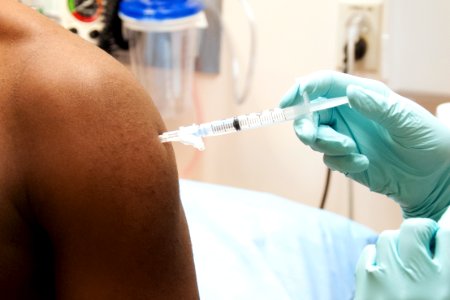 A man receiving a dose of the investigational NIAID/GlaxoSmithKline (GSK) Ebola vaccine. Original image sourced from US Government department: Public Health Image Library, Centers for Disease Control and Prevention. Under US law this image is copyright free, please credit the government department whenever you can”.