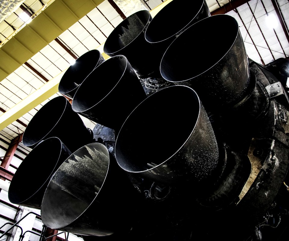 Falcon 9 first stage in hangar; upgraded Merlin engines close-up (2015).