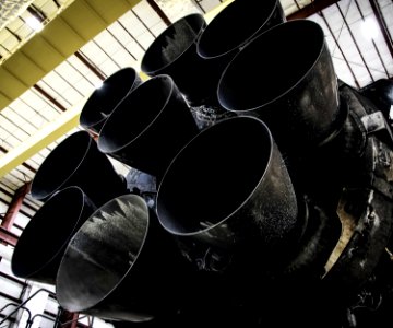 Falcon 9 first stage in hangar; upgraded Merlin engines close-up (2015).