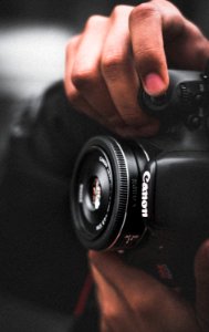 Person Holding Black Canon Dslr Camera Shallow Focus Photography photo
