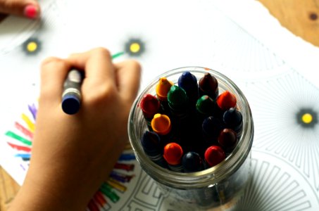 Kid Coloring With Crayons photo