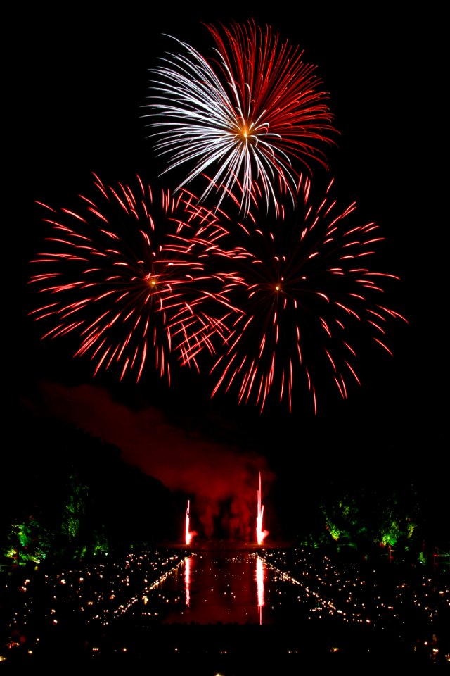 Red And White Fireworks Scattered During Nighttime