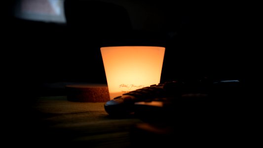 Black Remote Control Near Lamp Inside Dark Room