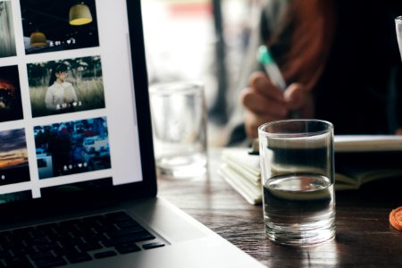 Water Glass Next To Laptop Computer