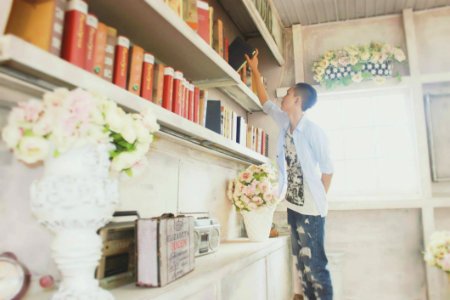 Man Takes Book Off Shelf