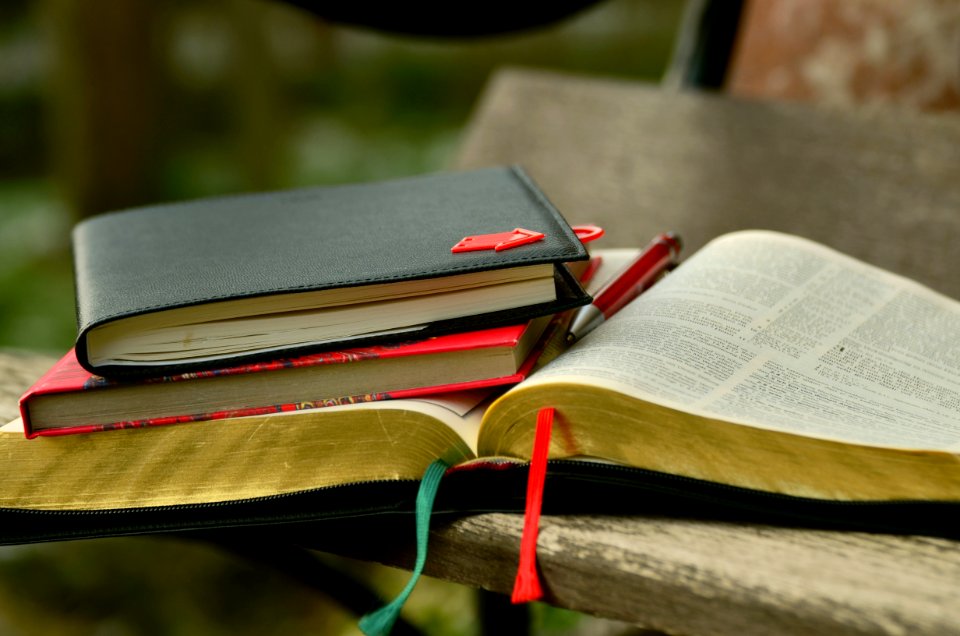 Black Hardbound Book On The Top Of The Book