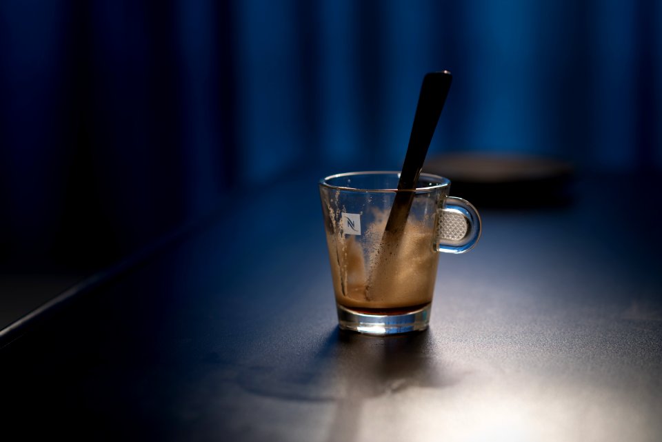 Black Stirring Rod On Clear Glass Cup