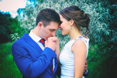 Man Kissing Womans Right Hand photo