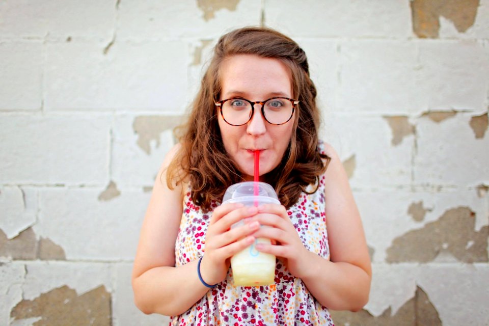 Woman In Black Framed Eyeglasses Drinking