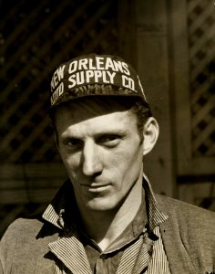 Black And White Photo Of Man Wearing New Orleans Supply Hat photo