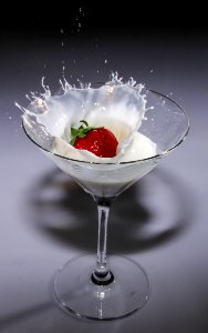 Clear Long Stem Wine Glass With Strawberry And White Liquid photo