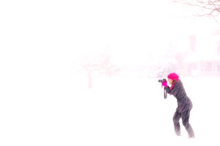 Woman In Pink Hijab Holding Black Dslr Camera Under Raging Snow During Daytime photo