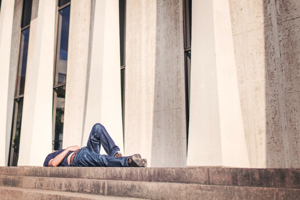 Person Laying On Outdoor Stairs