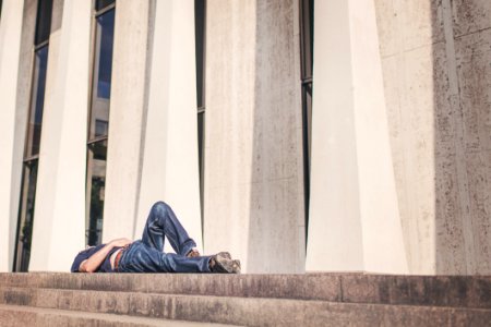 Person Laying On Outdoor Stairs photo