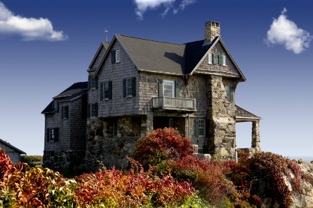 Photography Of Grey Concrete House Around The Red Green Leaves Plant Under The Blue Sky photo