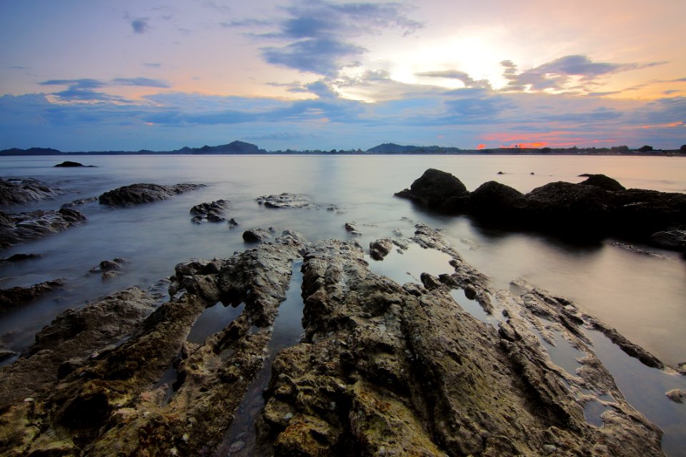 Top View Of Beach And Rocks Under Grey Cloudy Sky photo