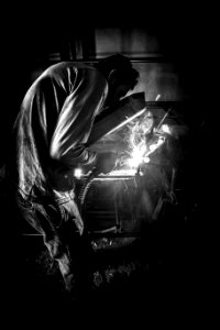 Greyscale Photo Of Person Having Welding photo