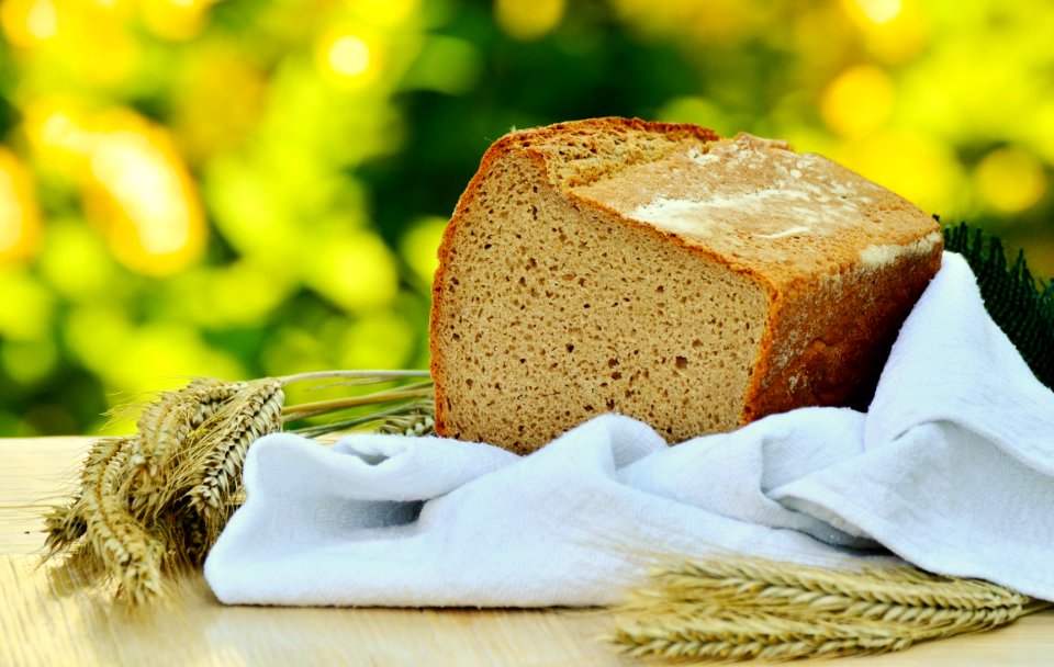 Brown Loft Bread In White Textile On Beige Table
