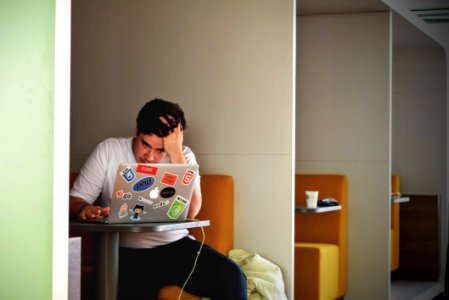 Man In White Shirt Using Macbook Pro