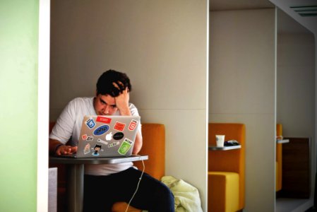 Man In White Shirt Using Macbook Pro photo