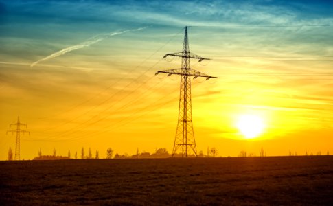 Electric Pole In Field At Sunset photo