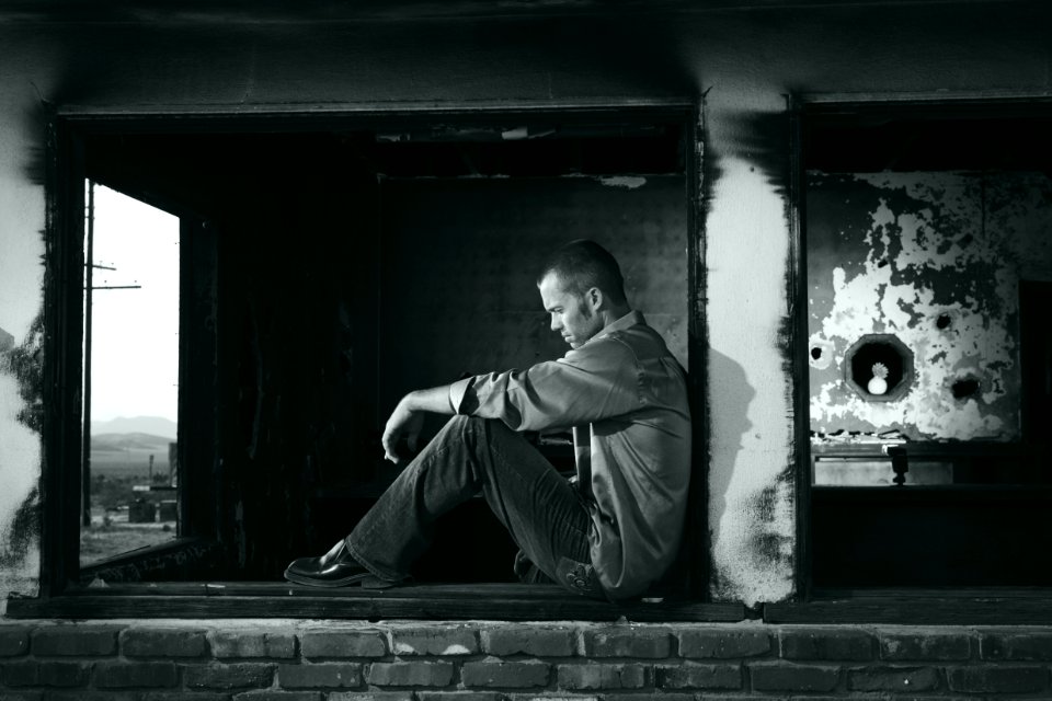 Urban Portrait Of Man Sitting Outdoors