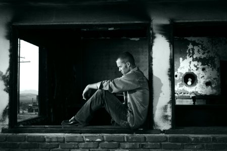 Urban Portrait Of Man Sitting Outdoors photo