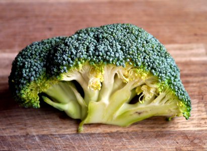 Green Broccoli Vegetable On Brown Wooden Table photo