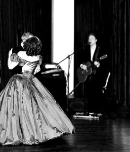 Man And Woman Dancing In Prom Apparel Near Man Singing