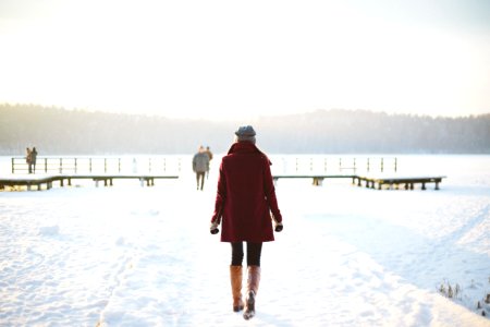 Woman Walking In Snowy Landscape