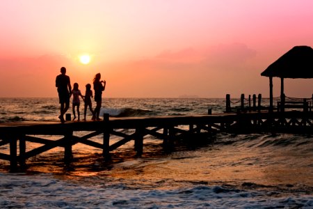 People Standing On Dock During Sunrise photo