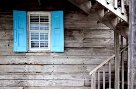 Wooden Cabin With Blue Shutters