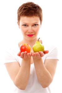 Woman Holding Red Apple And Green Peach photo