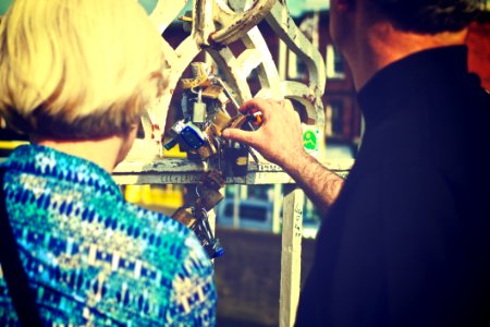 Couple Touching Padlocks Together