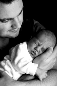 Grayscale Photo Of Man Holding Baby photo
