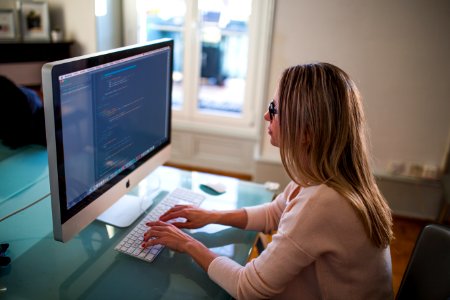 Woman Working On Desktop Computer photo