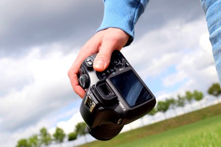 Person Carrying Digital Camera Outdoors