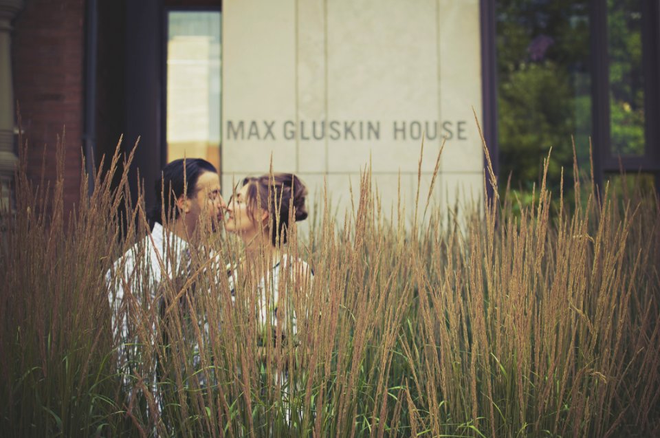 Man And Woman Kissing Near Green Plants