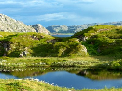 Scenic View Of Lake Against Cloudy Sky