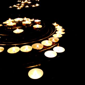 Illuminated Candles On Black Background