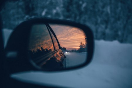 Sunset Over Horizon In Rear View Mirror